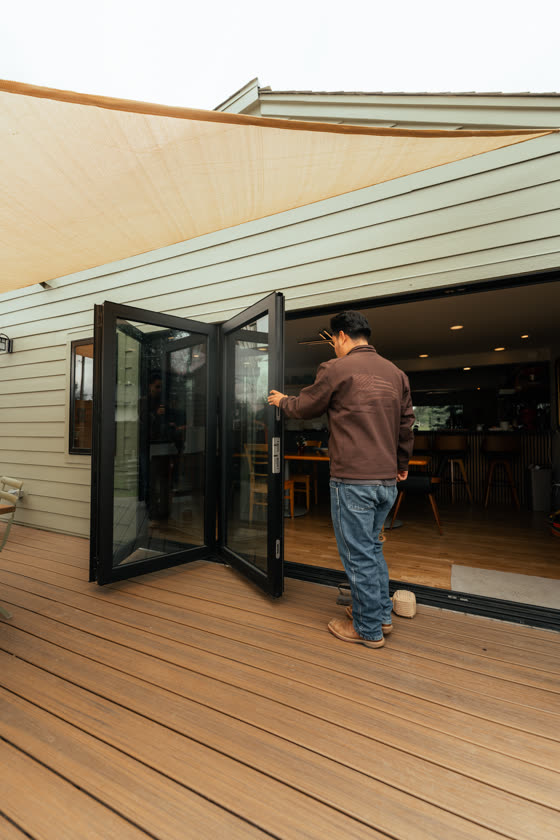 Bifold patio doors opening onto a finished wood deck