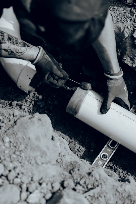 Cutting PVC pipe during a plumbing rough-in