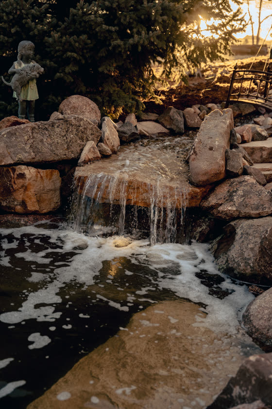 Water feature and statue lit at golden hour