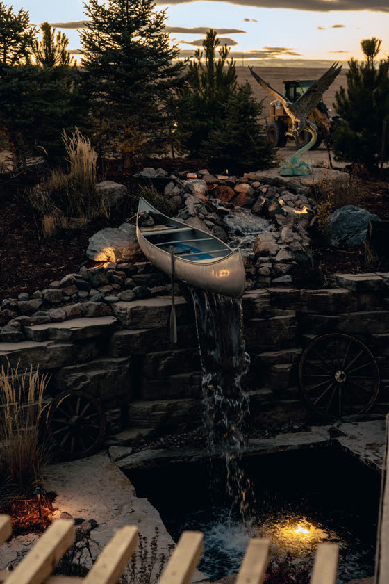 Backyard pond with a canoe at dusk