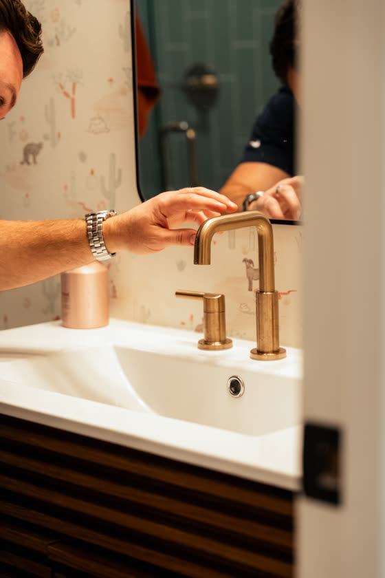 Brass bathroom faucet on a finished vanity